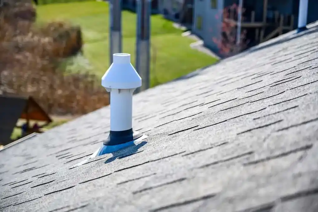 Pipe boot on asphalt roof that should be inspected for roof maintenance