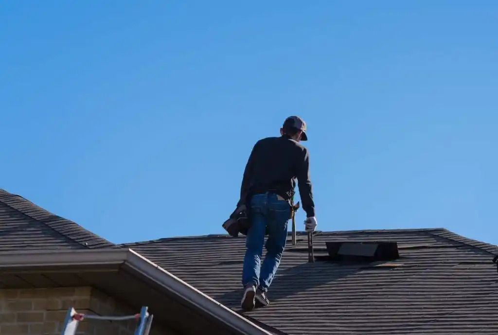 contractor walking showing how to repair shingles on a roof